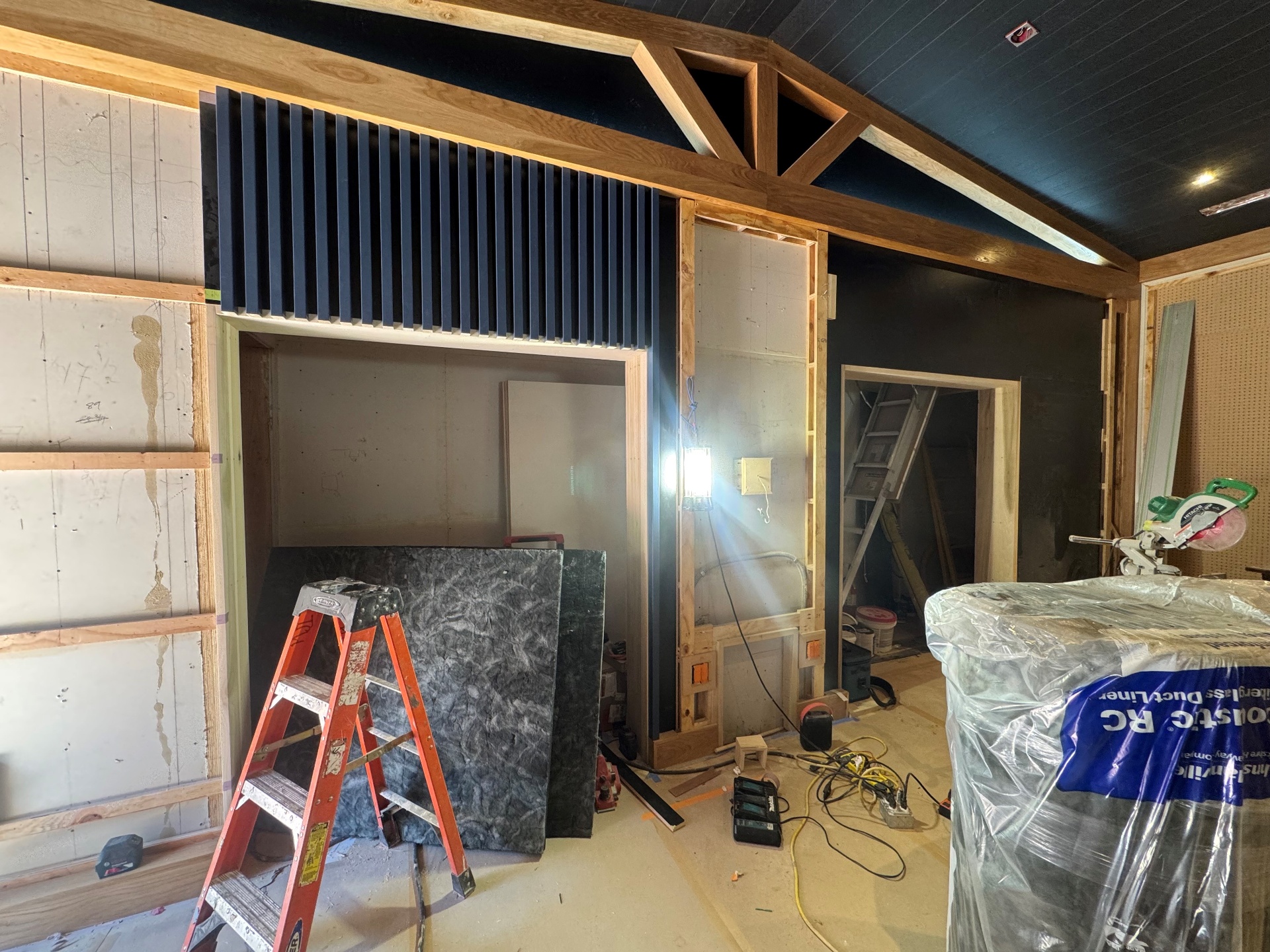 Glenwood Studio B live room during construction with exposed framing, acoustic slats, and vaulted ceiling